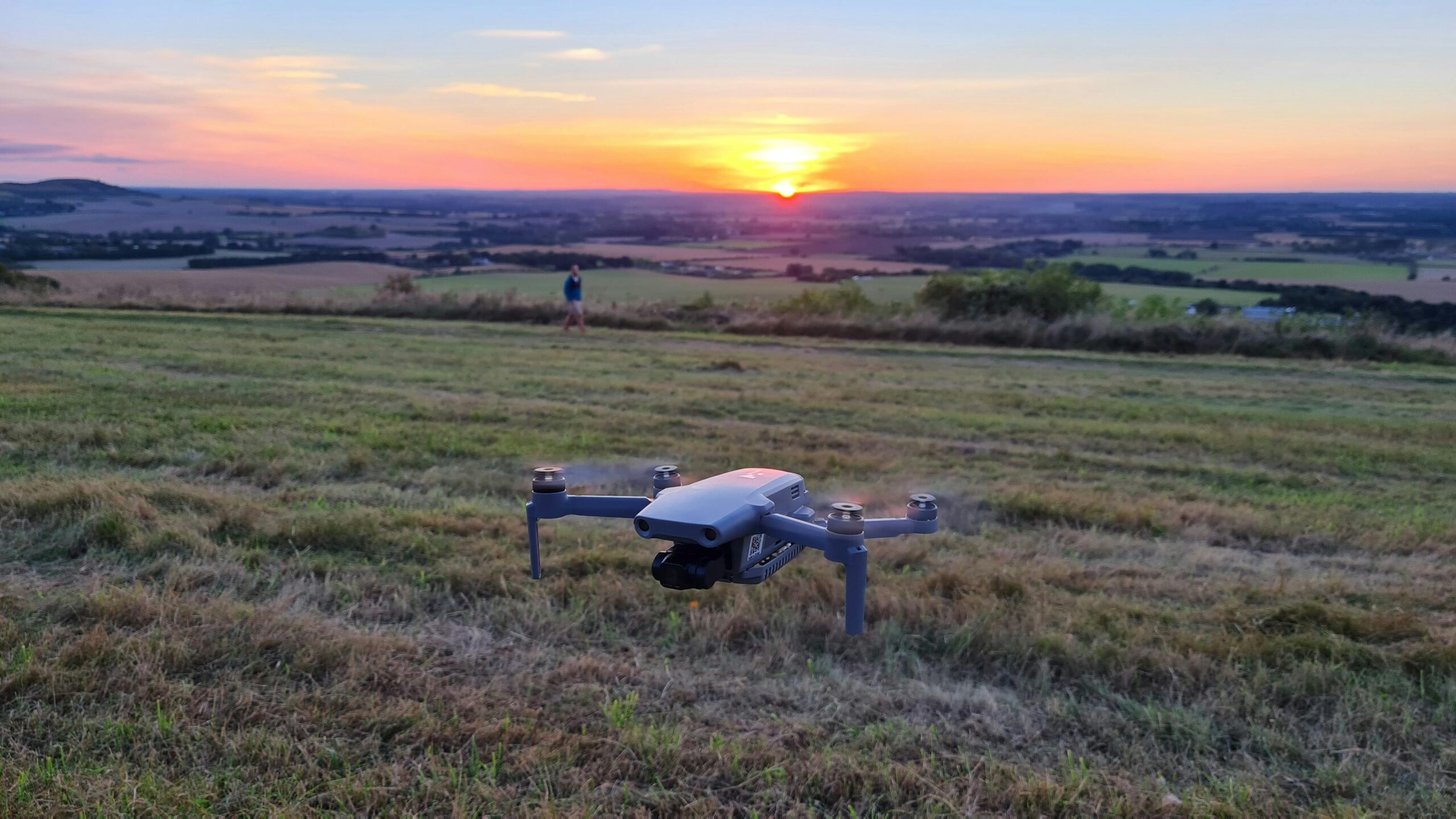 A tranquil aerial view of Totternhoe, England with a drone at sunset, showcasing rural farmland.
